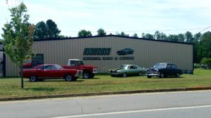 Four cars parked outside warehouse