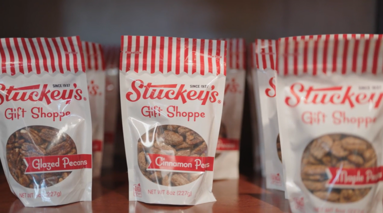 Bags of Stuckey’s Gift Shoppe pecans on a display shelf, labeled “Glazed Pecans” and “Cinnamon Pecans.”