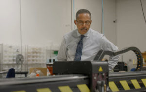 Russell Rainey monitors equipment at Rainey Apparel Manufacturing